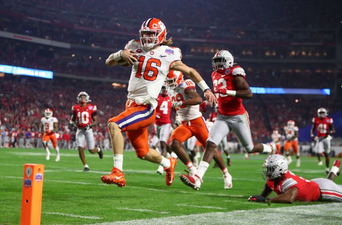 Clemson quarterback Trevor Lawrence scores a touchdown against Ohio State during the 2019 Fiesta Bowl at State Farm Stadium in Glendale, Arizona, on Saturday, December 28. <a href="index.php?page=&url=https%3A%2F%2Fwww.cnn.com%2F2019%2F12%2F28%2Fus%2Fcollege-football-playoff-semifinals-oklahoma-lsu-clemson-ohio-state-spt-trnd%2Findex.html" target="_blank">The Tigers defeated the Buckeyes 29-23 and will face LSU in the College Football Playoff National Championship.</a>