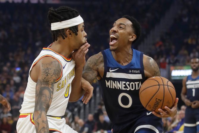 Minnesota Timberwolves' Jeff Teague drives to the basket against Golden State Warriors D'Angelo Russell during an NBA game on Monday, December 23, in San Francisco, California. The Warriors beat the Timberwolves 113-104.