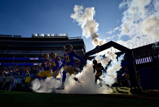 The Los Angeles Rams run onto the field before a game against the Arizona Cardinals in Los Angeles on Sunday, December 29.