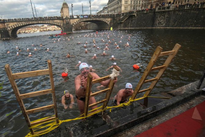 Swimmers emerge from the Vltava River during the traditional Christmas swimming event on Thursday, December 26, in Prague.