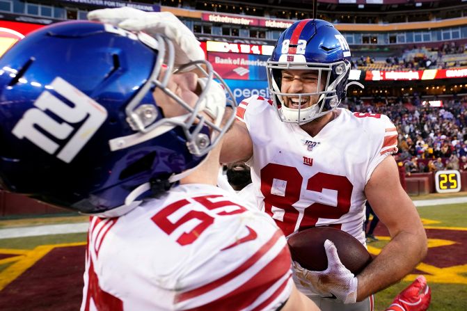New York Giants' Kaden Smith celebrates with David Mayo after scoring the winning touchdown against the Washington Redskins at FedExField on Sunday, December 22, in Landover, Maryland. The Giants won 41-35 in overtime.