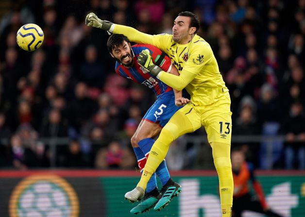 Crystal Palace's James Tompkins and West Ham United goalie Roberto Jiménez battle for the ball during a match at Selhurst Park in London on Thursday, December 26.