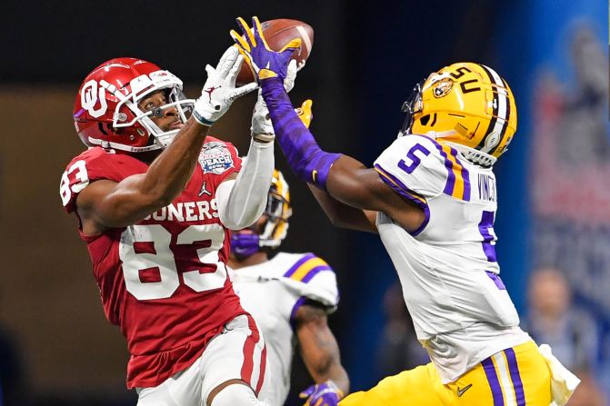 LSU cornerback Kary Vincent intercepts a pass intended for Oklahoma wide receiver Nick Basquine during the 2019 Peach Bowl in Atlanta, Georgia, on Saturday, December 28. <a href="index.php?page=&url=https%3A%2F%2Fwww.cnn.com%2F2019%2F12%2F28%2Fus%2Fcollege-football-playoff-semifinals-oklahoma-lsu-clemson-ohio-state-spt-trnd%2Findex.html" target="_blank">The Tigers defeated the Sooners 63-28 and will face off against Clemson in the College Football Playoff National Championship. </a>