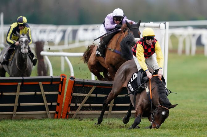 Robert Dunne riding Howling Milan fall after leading in the Betway Heed Your Hunch Handicap Hurdle in Newbury, England, on Saturday, December 28. <a href="index.php?page=&url=http%3A%2F%2Fwww.cnn.com%2F2019%2F12%2F23%2Fsport%2Fgallery%2Fwhat-a-shot-1223%2Findex.html" target="_blank">See 35 more amazing sports photos</a>
