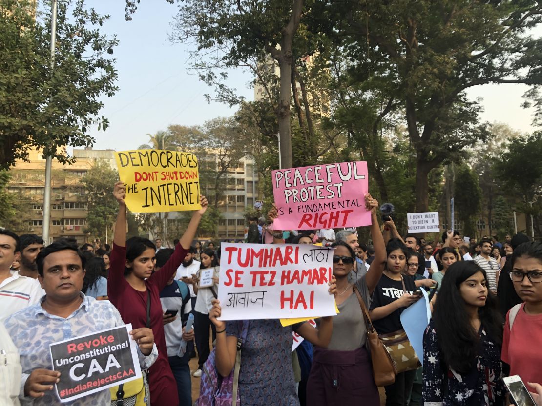 Protestors hold up their signs at the Gowali Tank Maidan in Mumbai. 