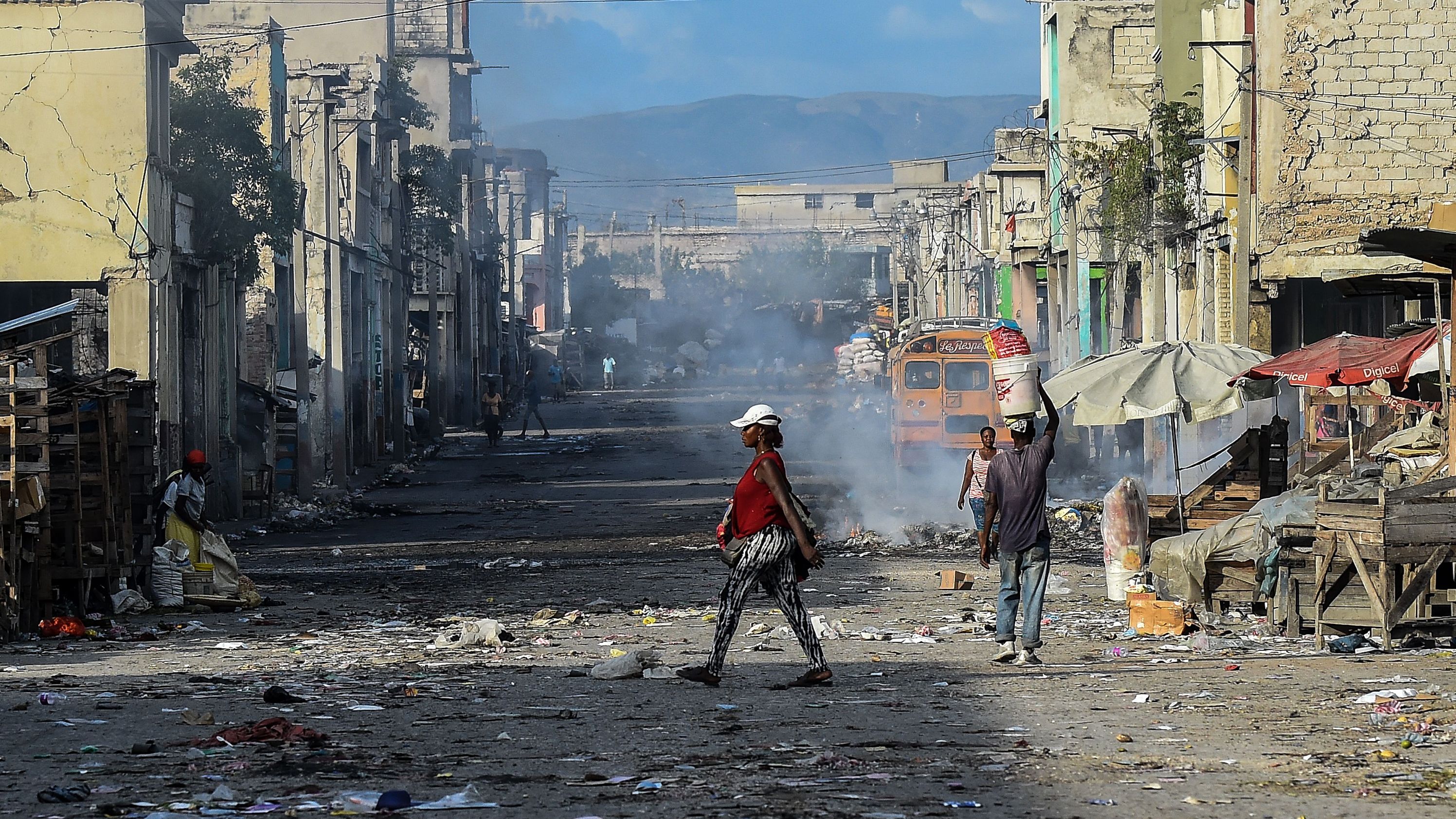 People walk in downtown  Port-au-Prince on December 20, 2019. The country's infrastructure remains in dire need of repair.