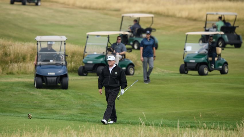 TURNBERRY, UNITED KINGDOM - JULY 14:  U.S. President Donald Trump, wearing a hat with Trump and USA displayed on it,  plays golf at Trump Turnberry Luxury Collection Resort during the President's first official visit to the United Kingdom on July 14, 2018 in Turnberry, Scotland. The President of the United States and First Lady, Melania Trump on their first official visit to the UK after yesterday's meetings with the Prime Minister and the Queen is in Scotland for private weekend stay at his Turnberry.  (Photo by Leon Neal/Getty Images)