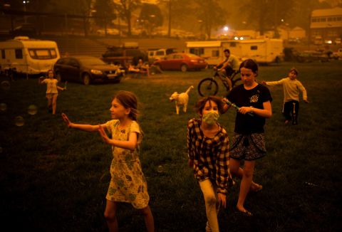 Children evacuated from areas affected by bushfires play at the showgrounds in the southern New South Wales town of Bega on December 31.
