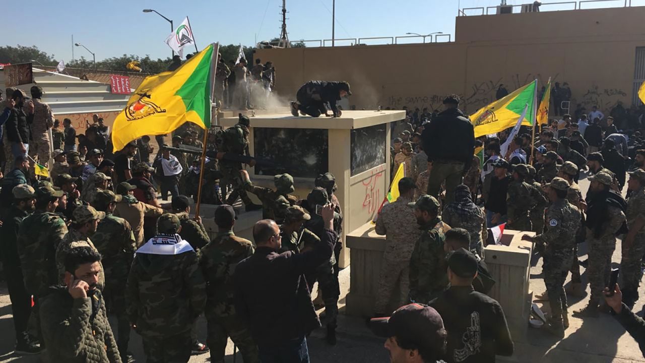 Iraqi protesters try to storm the US Embassy in Baghdad on Tuesday.