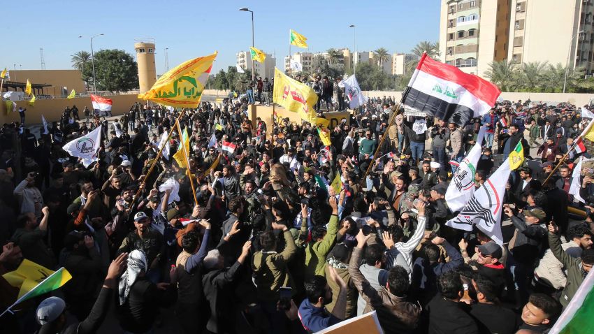 Several thousand Iraqi protesters, waving national flags and banners of the Hashed al-Shaabi, a mostly Shiite network of local armed groups trained and armed by powerful neighbour Iran, demonstrate outside the US embassy in Baghdad on December 31, 2019, breaching its outer wall and chanting "Death to America!" in anger over weekend air strikes that killed pro-Iran fighters. - It was the first time in years protesters have been able to reach the US embassy in the Iraqi capital, which is sheltered behind a series of checkpoints in the high-security Green Zone. (Photo by AHMAD AL-RUBAYE / AFP) (Photo by AHMAD AL-RUBAYE/AFP via Getty Images)