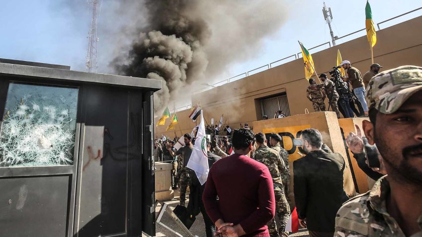 Members of the Iraqi pro-Iranian Hashed al-Shaabi group and protesters set ablaze a sentry box in front of the US embassy building in the capital Baghdad to protest against the weekend's air strikes by US planes on several bases belonging to the Hezbollah brigades near Al-Qaim, an Iraqi district bordering Syria, on December 31, 2019. - Several thousand Iraqi protesters attacked the US embassy in Baghdad on today, breaching its outer wall and chanting "Death to America!" in anger over weekend air strikes that killed pro-Iran fighters. (Photo by Ahmad AL-RUBAYE / AFP) (Photo by AHMAD AL-RUBAYE/AFP via Getty Images)