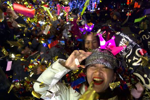 People celebrate the new year near the 2022 Beijing Winter Olympic headquarters.