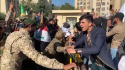 Baghdad protesters battering ram