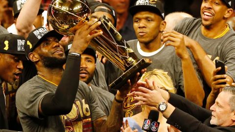 LeBron James hoists the Larry O'Brien trophy after his Cleveland Cavaliers beat the Golden State Warriors to win the NBA Finals in 2016.