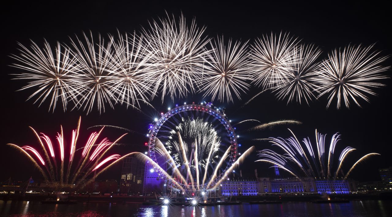 Fireworks explode over the London Eye by the River Thames in London.