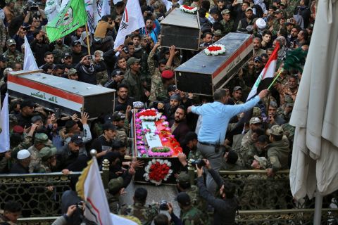 Mourners carry the coffins of Iranian-backed paramilitary fighters in Najaf, Iraq, on December 31. The fighters were killed in US airstrikes on Sunday that sparked Tuesday's attacks on the US Embassy in Baghdad.