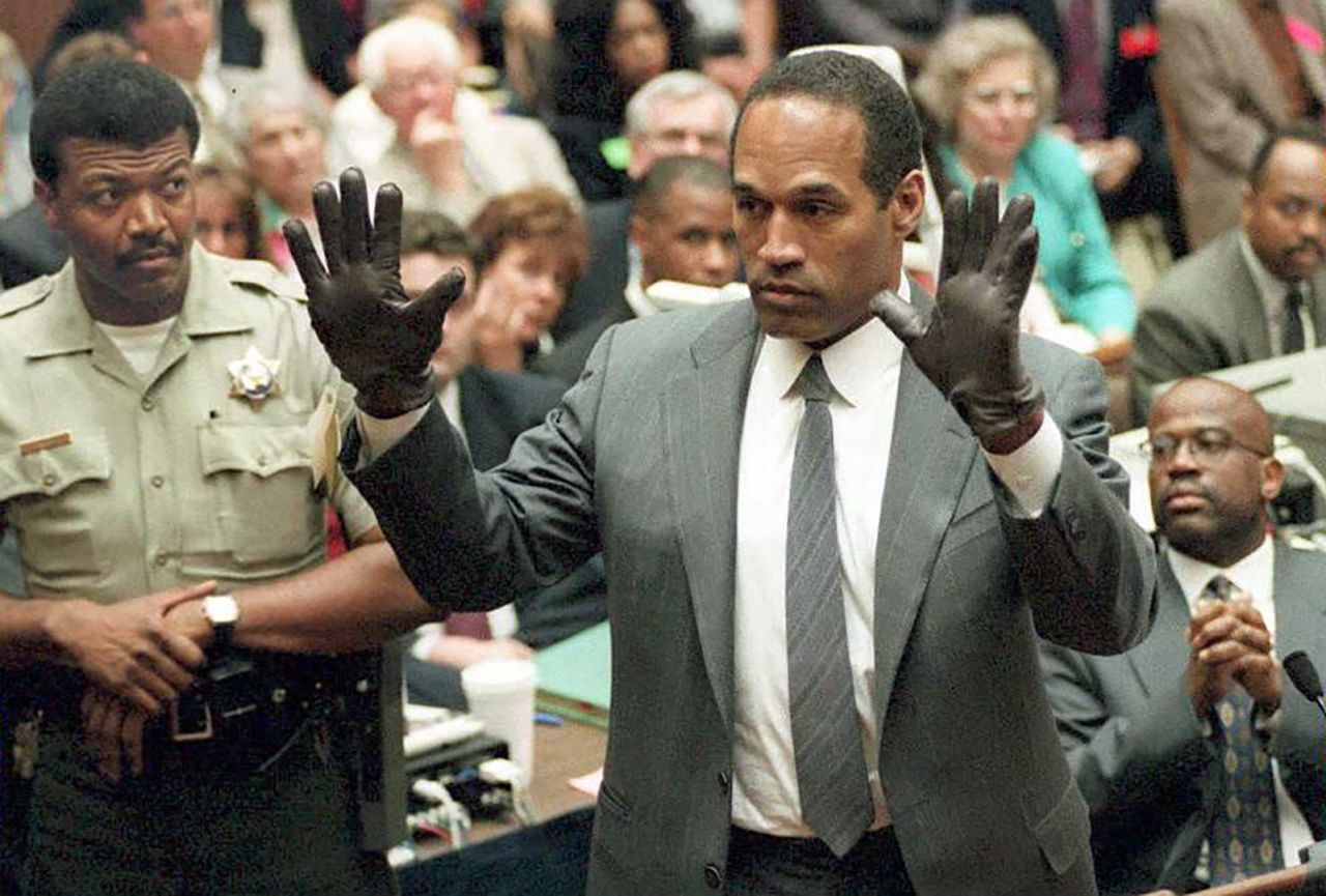 O.J. Simpson shows the jury a new pair of Aris extra-large gloves during his double murder trial in Los Angeles in 1995.