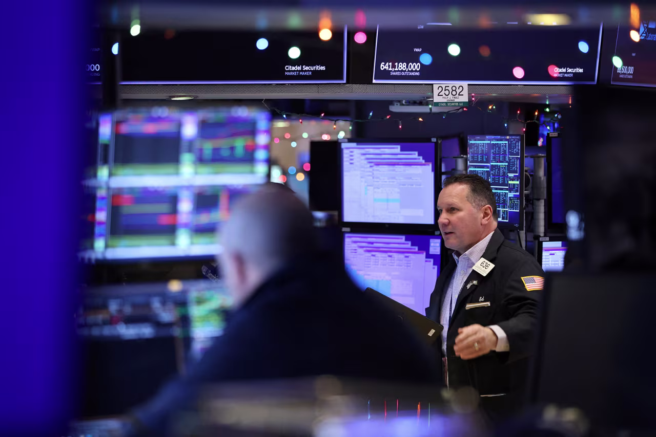 Traders work on the trading floor at the New York Stock Exchange on December 14.