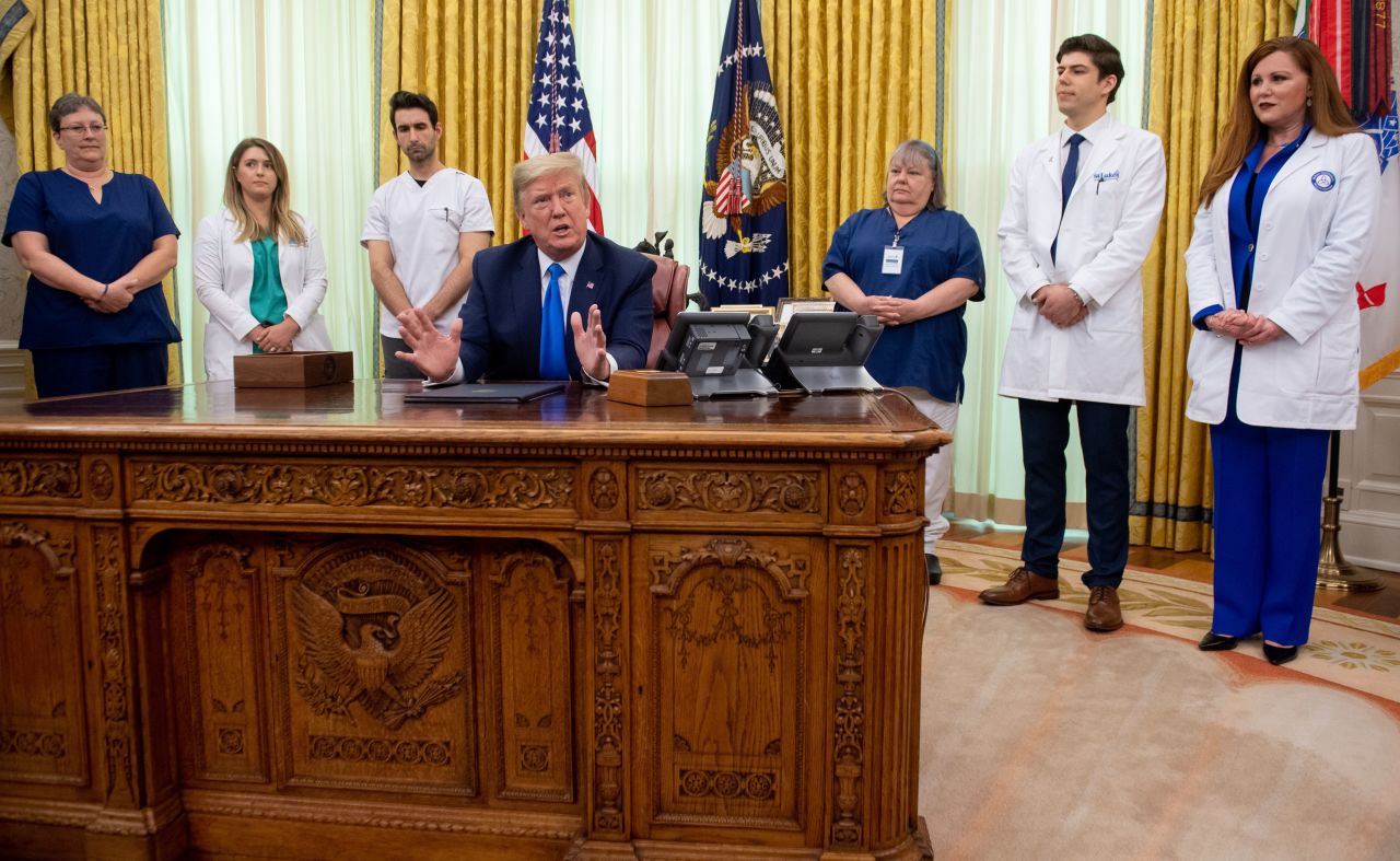 President Donald Trump, flanked by nurses, speaks at the White House on May 6 after signing a proclamation in honor of National Nurses Day.