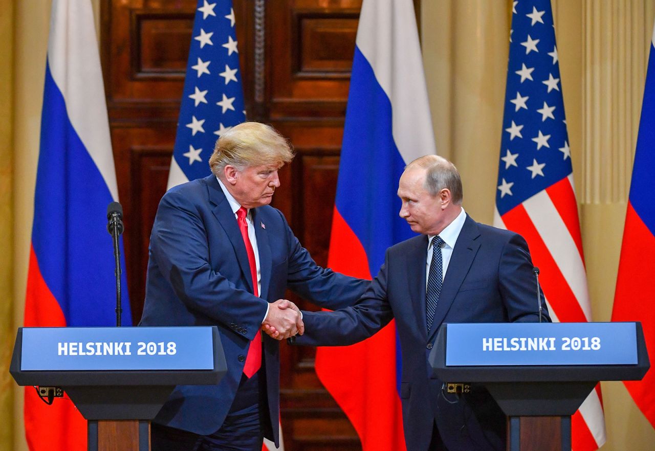 Former US President Donald Trump and Russia's President Vladimir Putin shake hands before attending a joint press conference after a meeting at the Presidential Palace in Helsinki, on July 16, 2018.