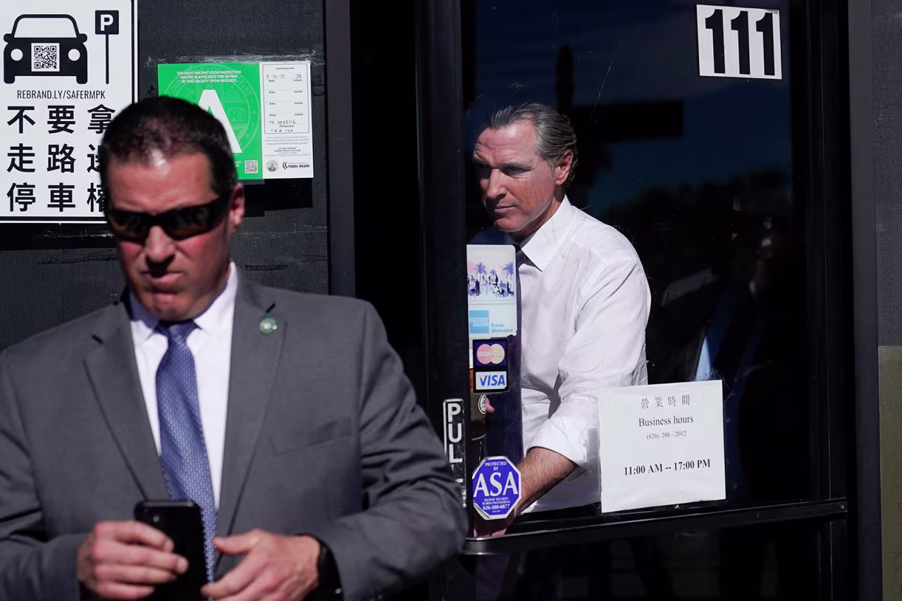 Gavin Newsom walks out of a shop in Monterey Park, California, on Monday, January 23.