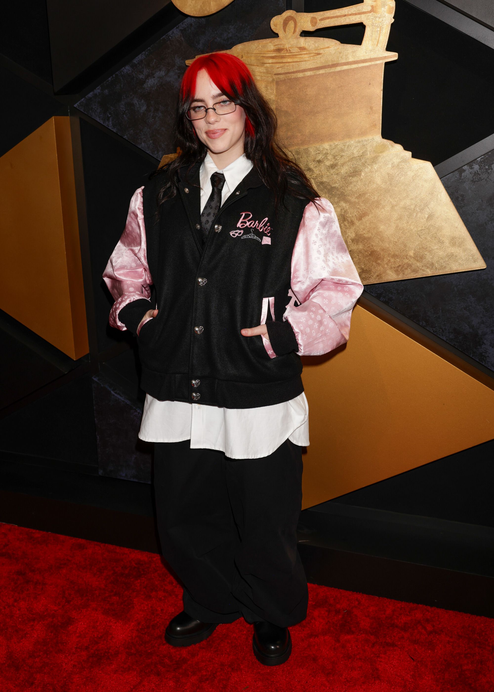 Billie Eilish, who shares a stylist with Margot Robbie, arrived in a Barbie varsity jacket by Chrome Hearts.