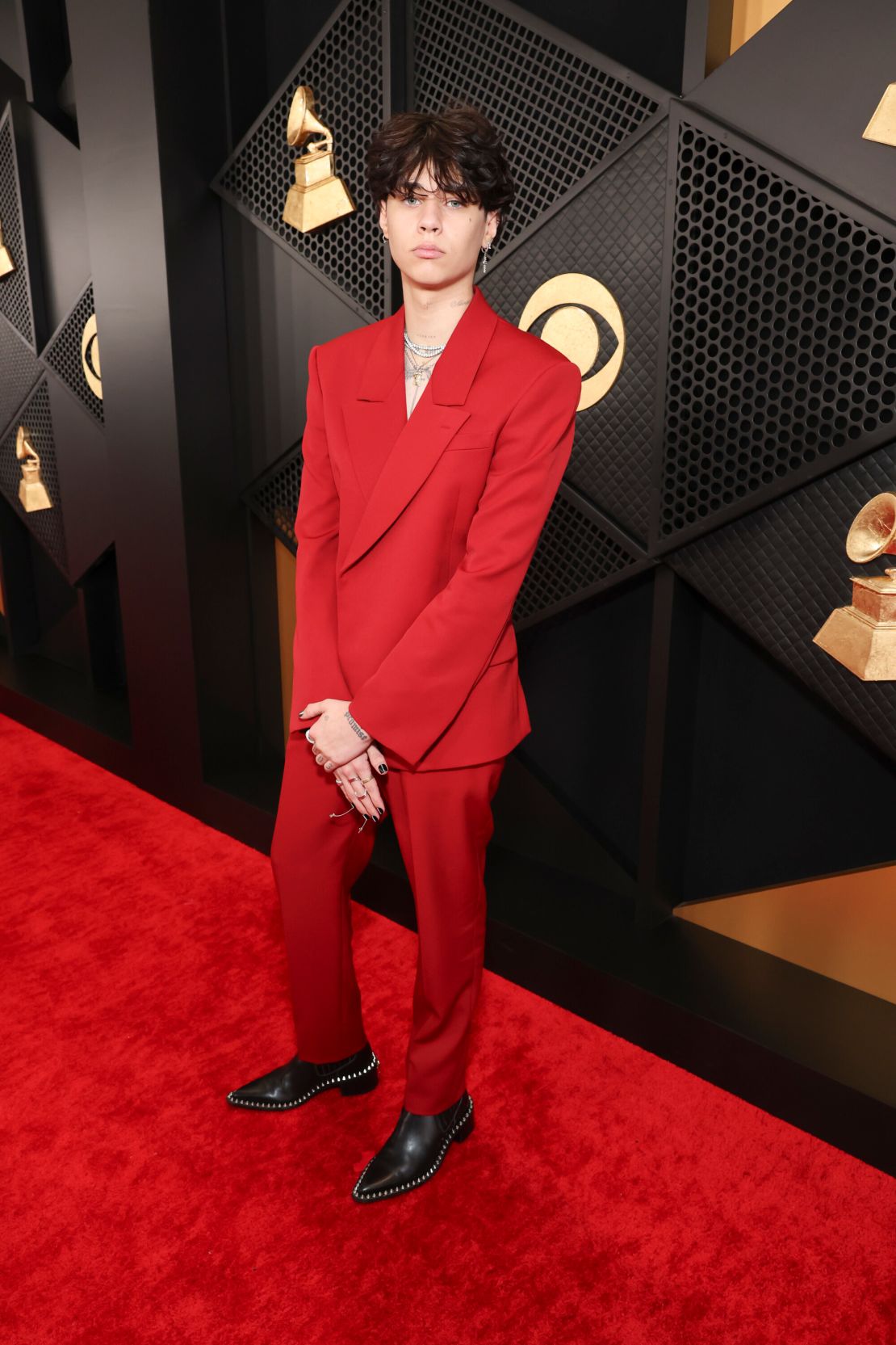 Musician Travis Barker’s son, Landon Barker, went shirtless underneath his all-red suit.