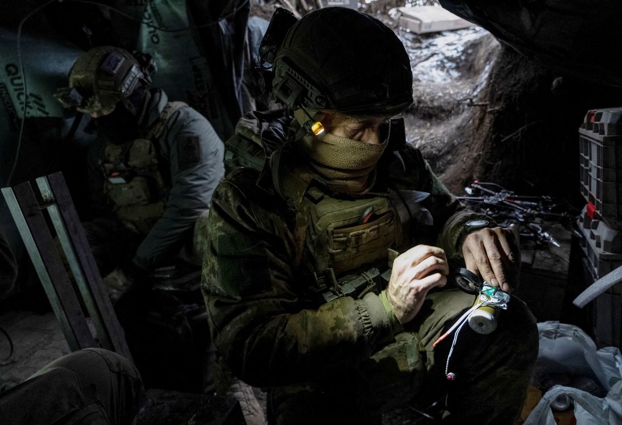 A Ukrainian serviceman prepares a shell for a drone at his position at a front line near the town of Avdiivka, in Ukraine's Donetsk region, on February 20. 