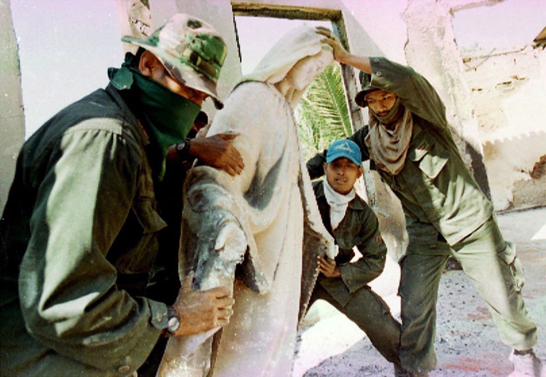 Indonesian troops remove a statue of the Virgin Mary while cleaning up the house of Bishop Belo in Dili on September 18, 1999. Belo was one of tens of thousands forced to leave the area when pro-Jakarta militias unleashed a wave of violence following a vote for independence from Indonesia.