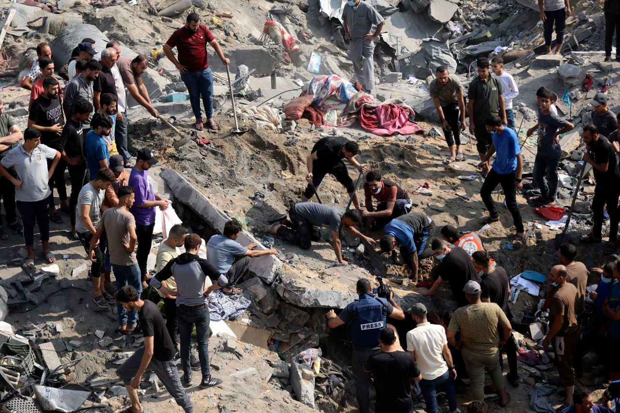 Palestinians work among debris of buildings that were targeted by Israeli airstrikes in Jabalya refugee camp in Gaza on November 1. 