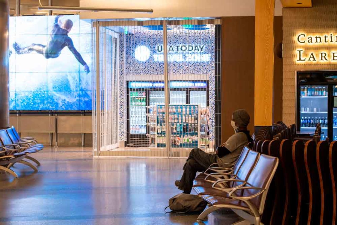 A person wearing a mask waits for a flight at the Tom Bradley Terminal at Los Angeles International Airport (LAX) during the outbreak of the novel coronavirus on April 16.