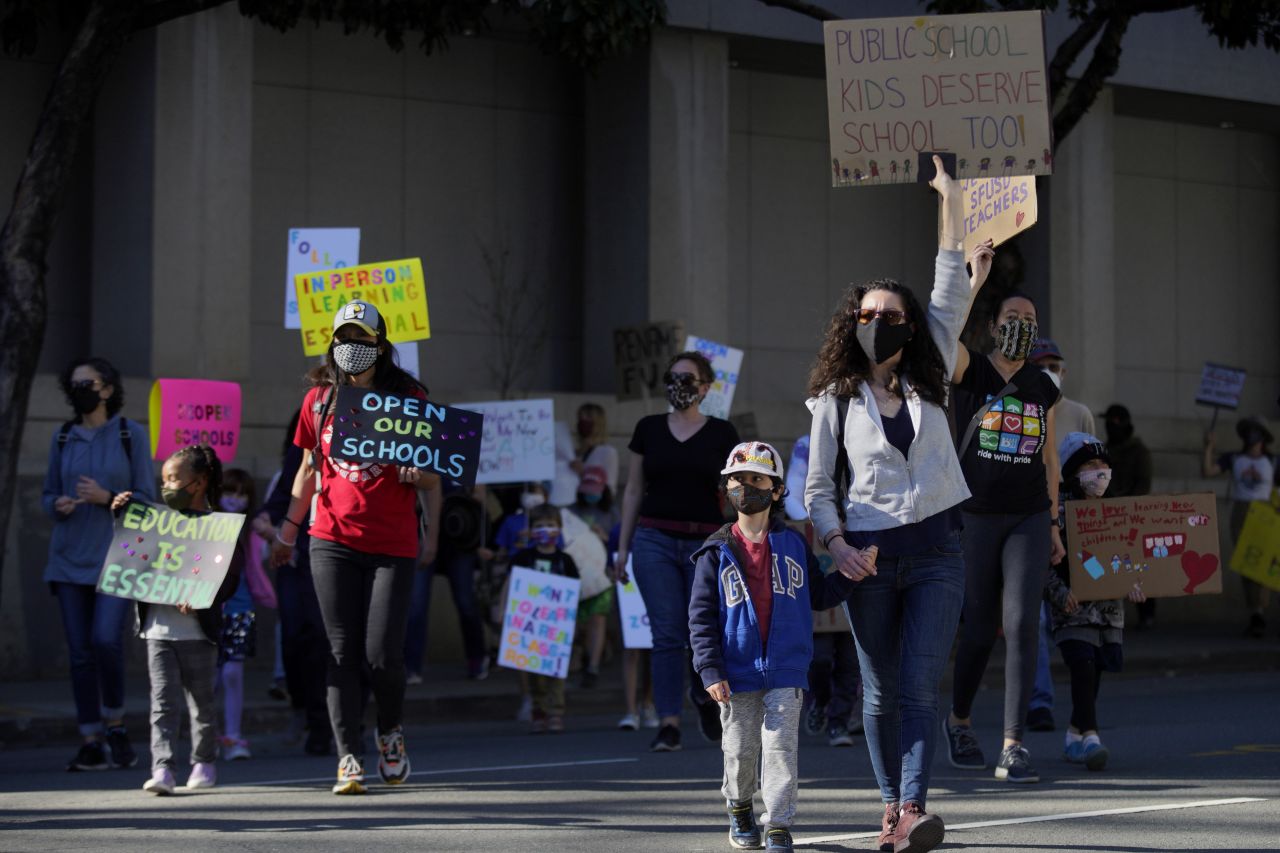 Hundreds of people march to City Hall in San Francisco, California, on February 6, to protest against remote learning and demand schools reopen in-person education. 