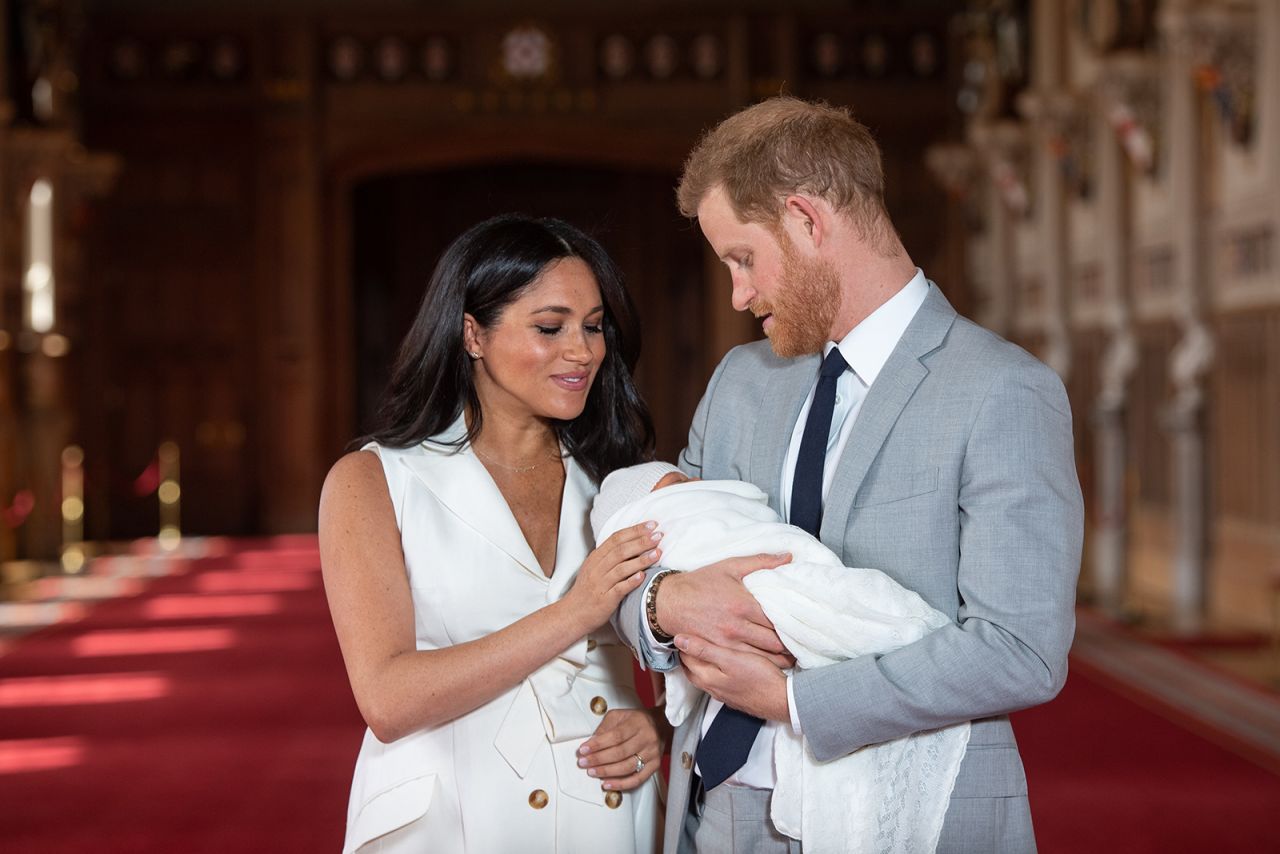 Prince Harry, Duke of Sussex and Meghan, Duchess of Sussex, pose with their newborn son Archie Harrison Mountbatten-Windsor during a photo call in St George's Hall at Windsor Castle on May 8, 2019 in Windsor, England. 