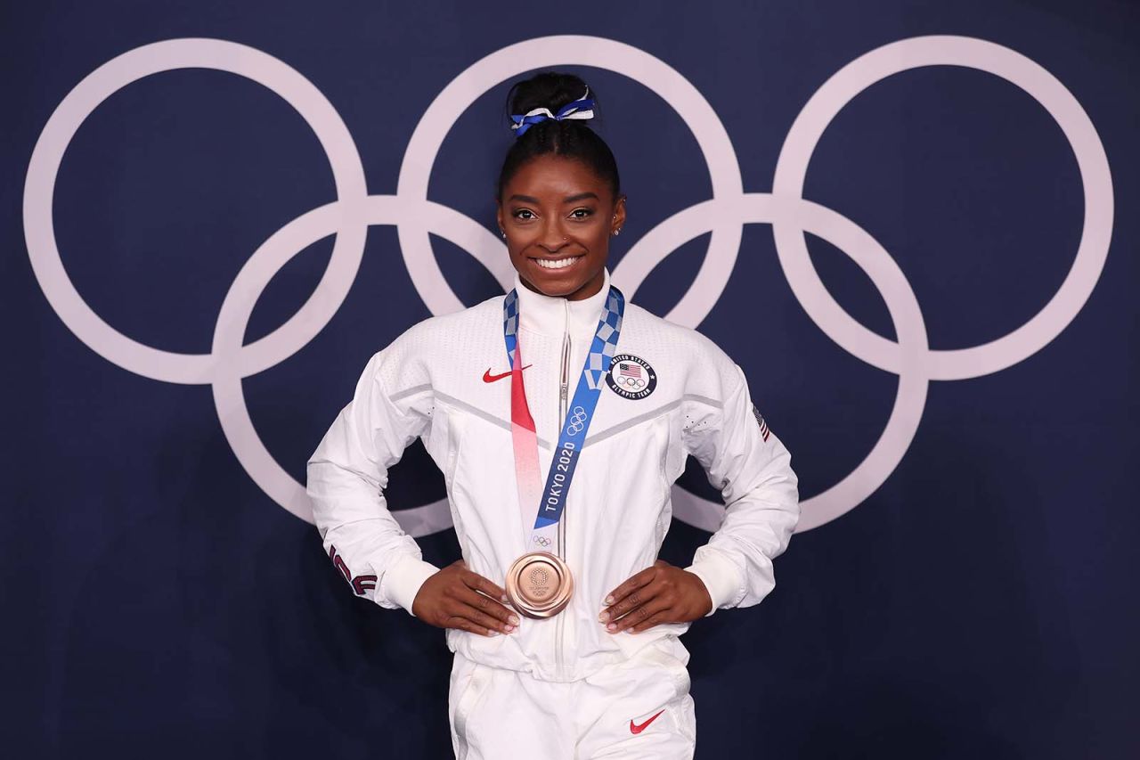 Simone Biles poses with her bronze medal following the women's balance beam final on August 3.