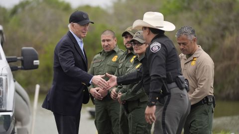 President Joe Biden talks with the US Border Patrol and local officials, as he looks over the southern border on Thursday. 