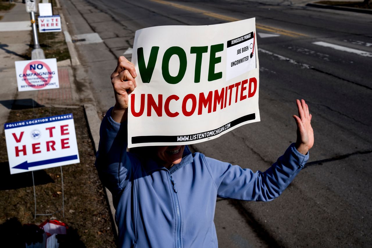 A volunteer holds a "Vote Uncommitted" sign outside of a polling station at Oakman School in Dearborn, Michigan, on February 27.