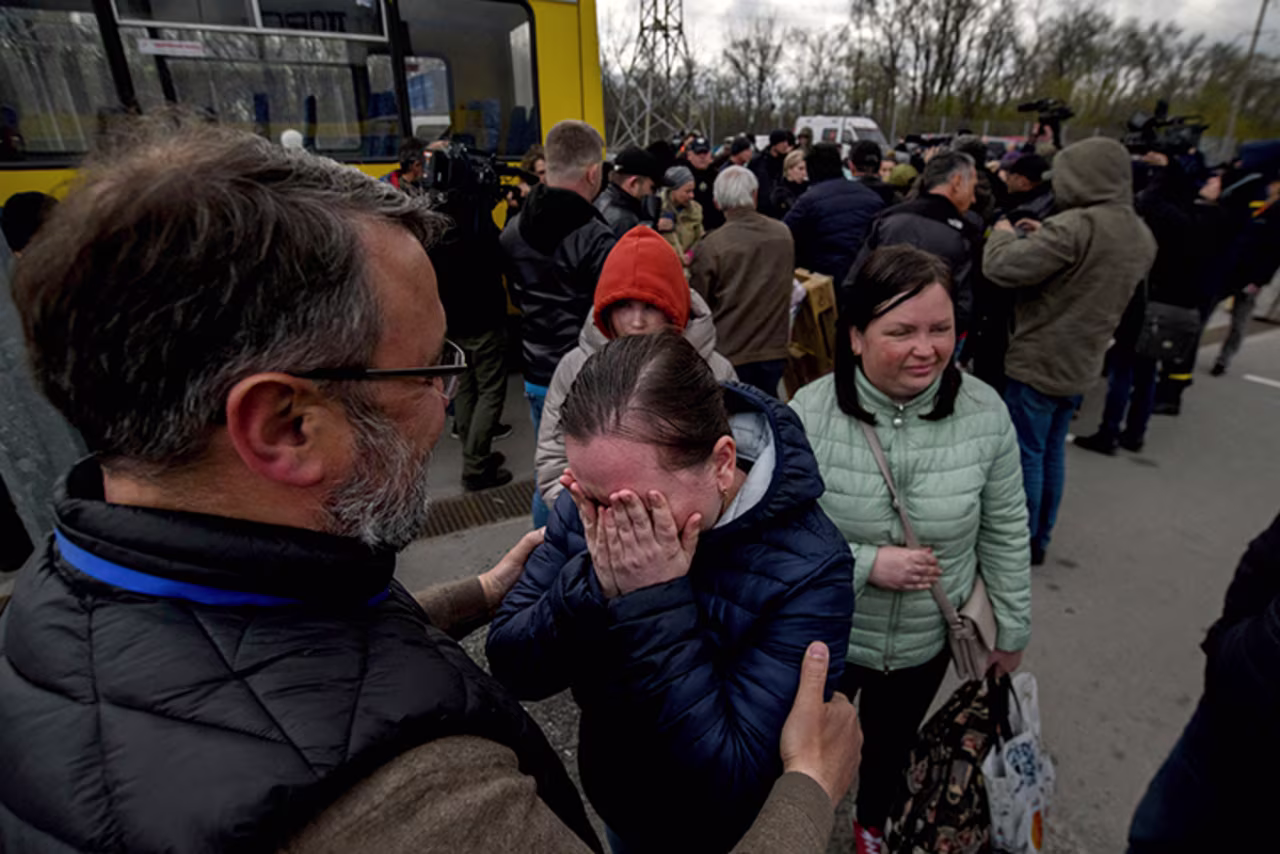 People fleeing fighting Mariupol meet with relatives and friends as at a registration center for internally displaced people in Zaporizhzhia on Thursday, April 21.