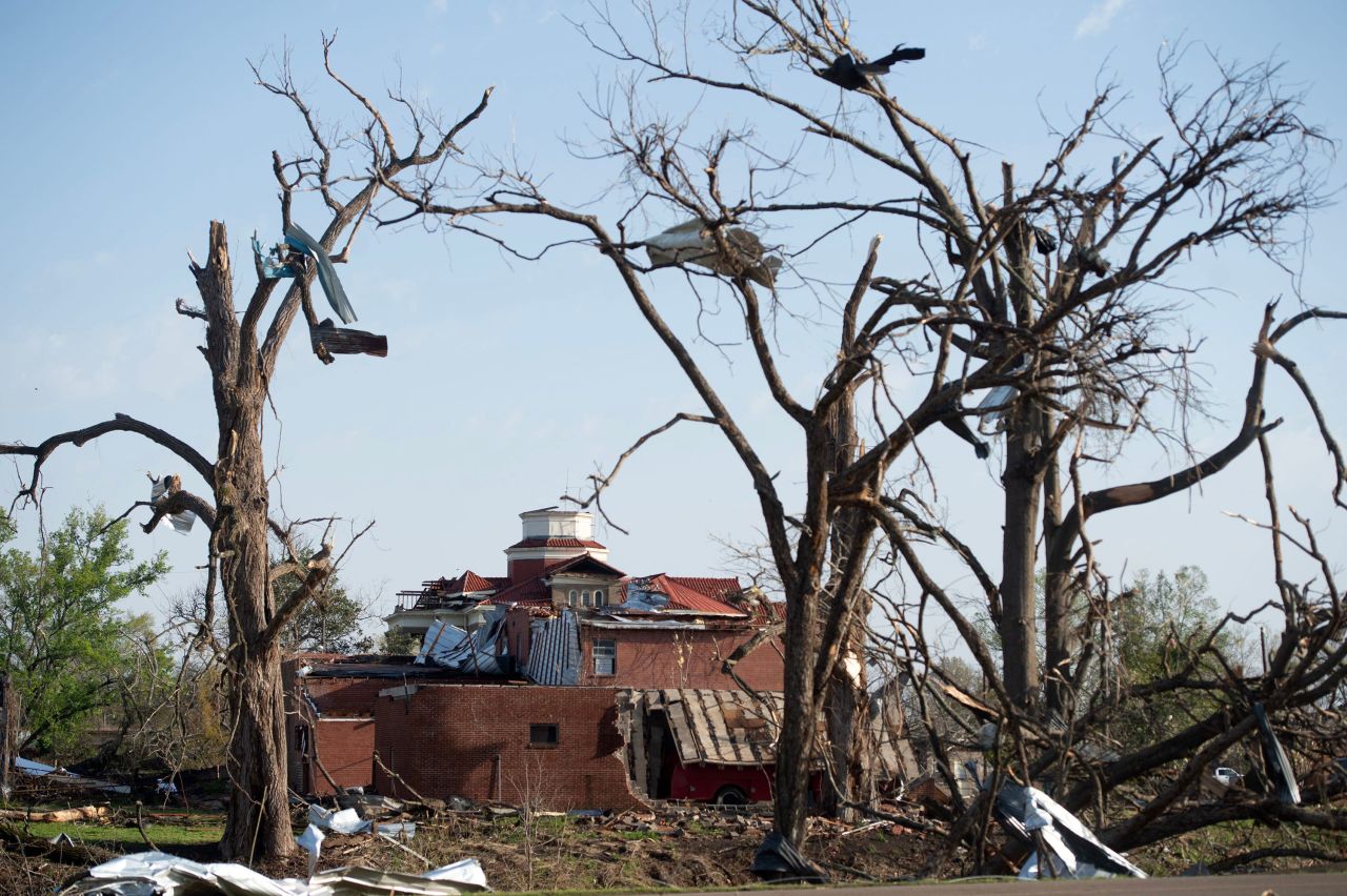 The heavily damaged Sharkey County Courthouse in Rolling Fork, Mississippi, stands framed by debris-filled trees on Saturday, March 25, after a tornado devastated the Delta town Friday night. 