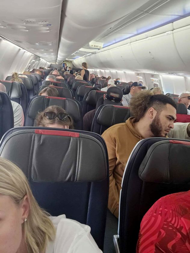 People wait on a plane at Dallas Fort Worth airport on Friday, September 19