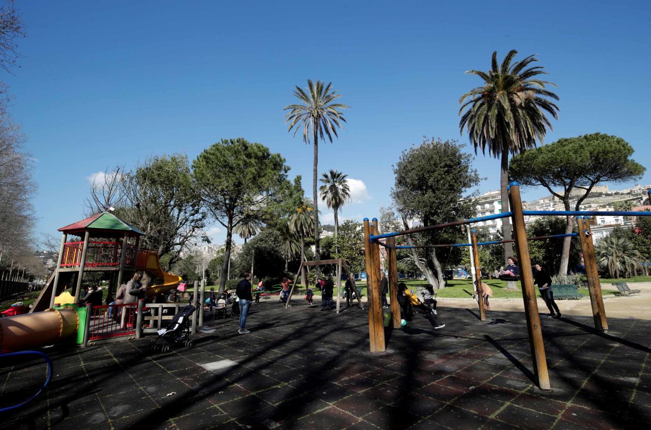 Children play in a park after the Italian government declared the closure of schools in Naples, Italy, on Thursday.