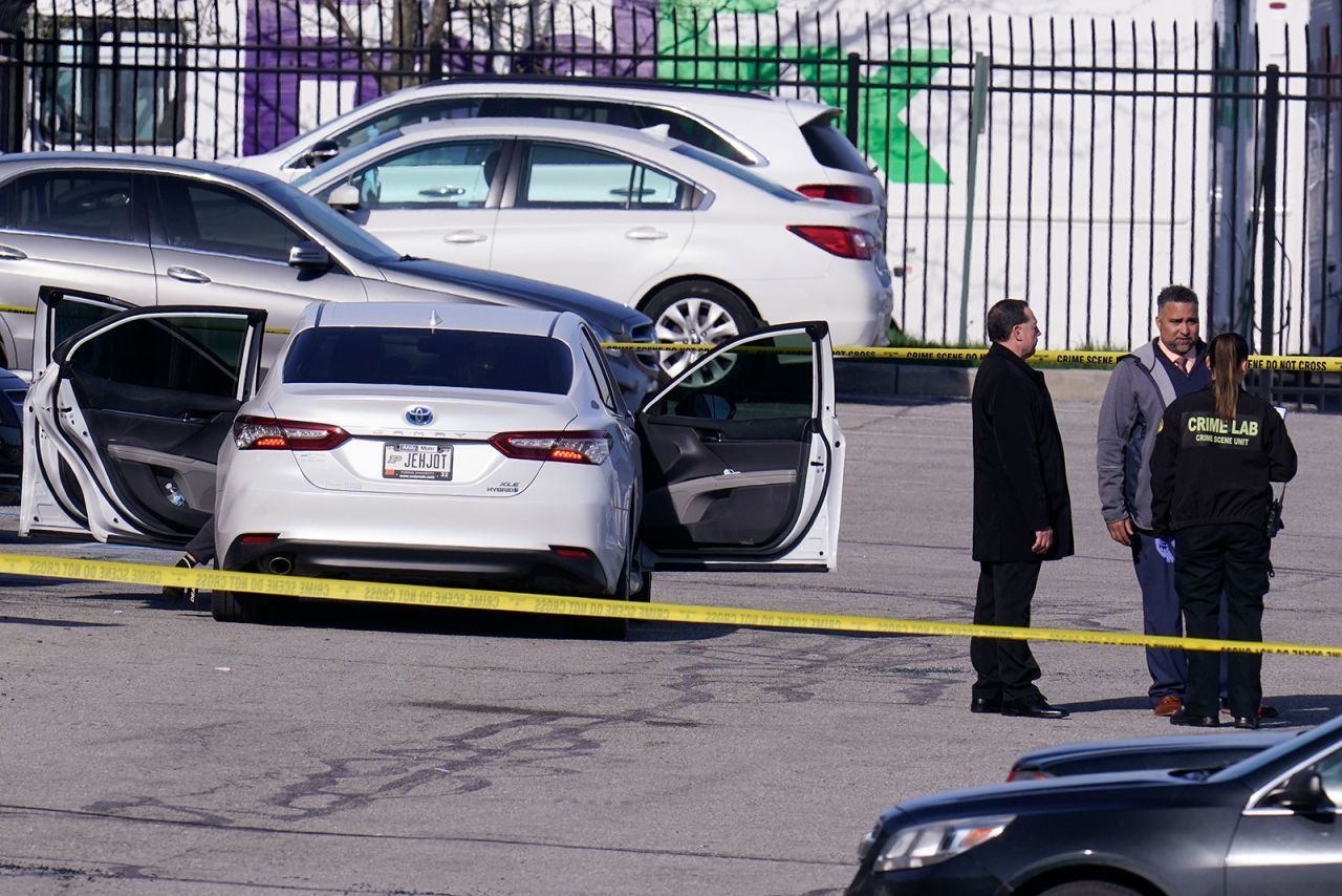 Authorities work outside the FedEx facility in Indianapolis on Friday.