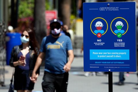 Signs instruct visitors on the proper way to wear masks at the Universal City Walk in Universal City, California, on May 14. 