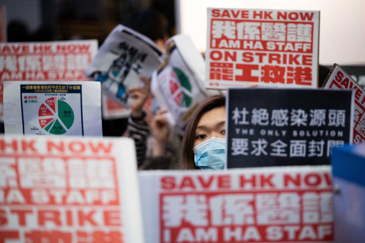 A masked medical worker is seen among placards during a strike outside the Hospital Authority building in Hong Kong on Tuesday.