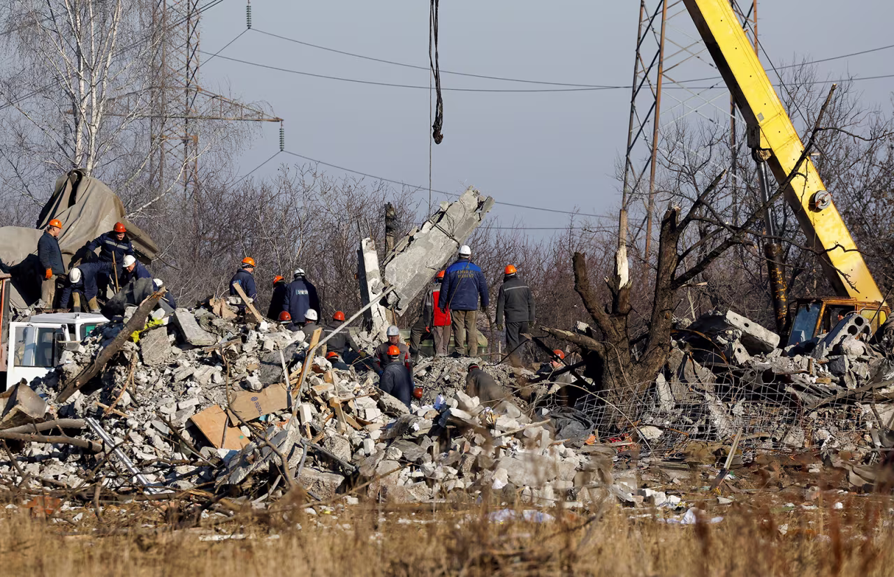 Workers remove debris of a destroyed building following a Ukrainian missile strike in Makiivka, on January 3.