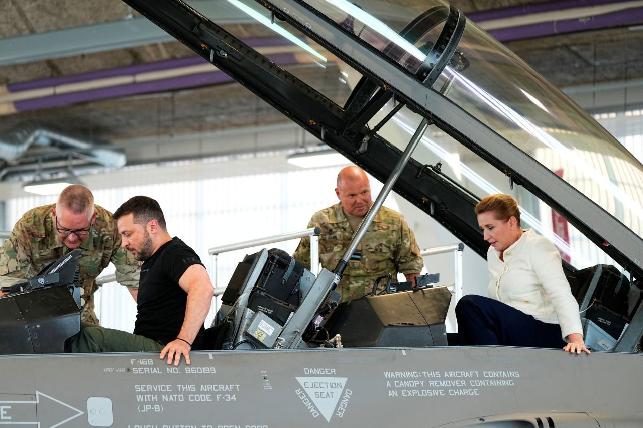 Ukrainian President Volodymyr Zelenskiy and Denmark's Prime Minister Mette Frederiksen sit in a F-16?fighter jet at Skrydstrup Airbase in Vojens, Denmark, on August 20, 2023.