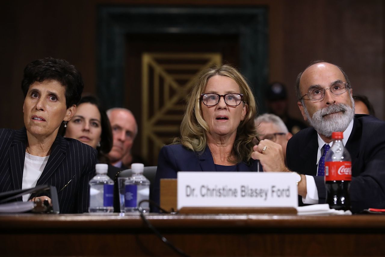 Christine Blasey Ford (C) is flanked by her attorneys Debra Katz (L) and Michael Bromwich as she testifies 