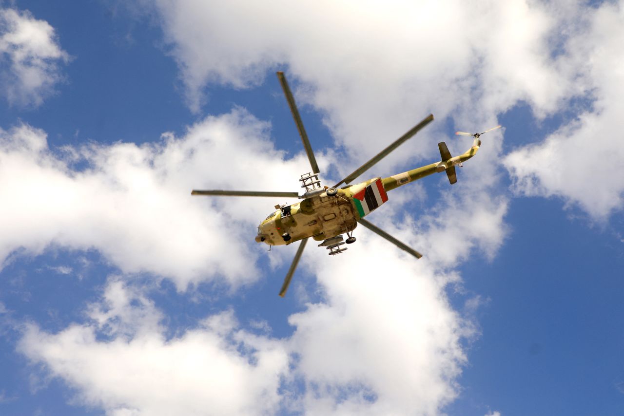 A Houthi operated helicopter, bearing a Palestinian and a Yemeni flag, flying over protesters during a march in solidarity with the people of Gaza, in the Houthi-controlled capital of Sanaa in Yemen on January 5.