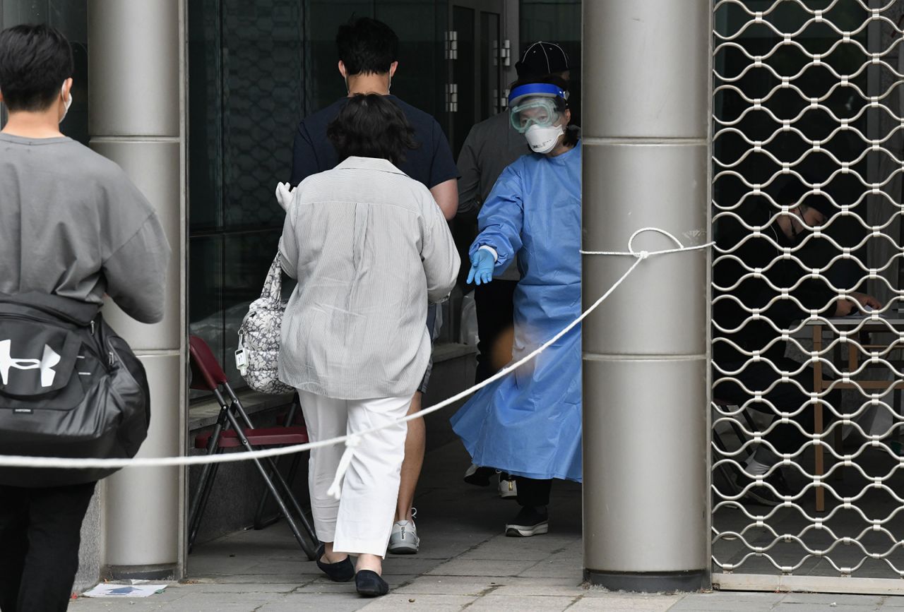 A medical worker guides visitors to take a Covid-19 test in the nightlife district of Itaewon in Seoul on May 12.