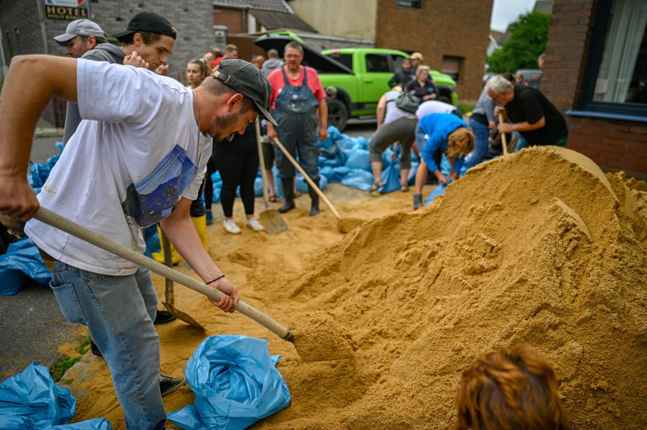 Residents fill bags with sand to protect against flooding on July 16 in Erftstadt, Germany. 