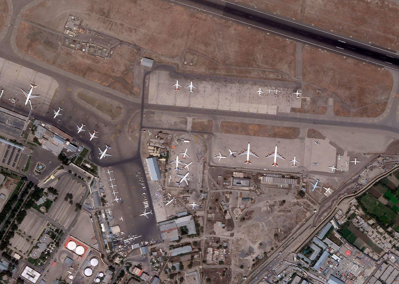 This satellite image from Planet Labs shows people on the tarmac at Hamid Karzai International Airport in Kabul, Afghanistan, on August 16, 2021.